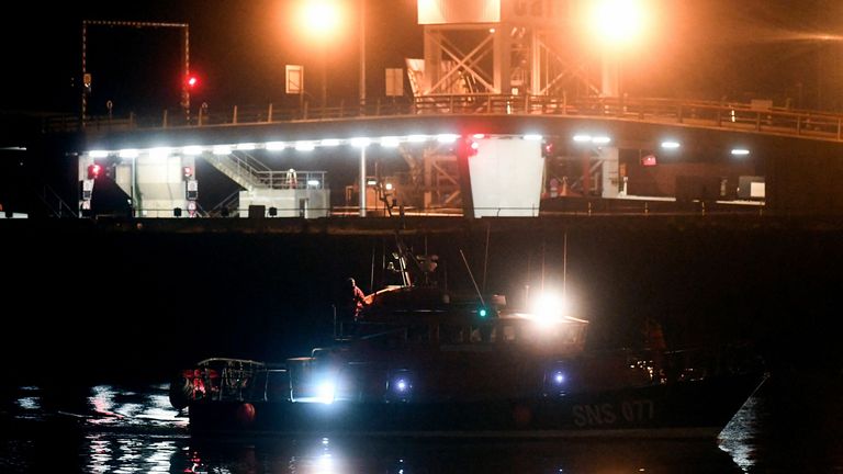 Police officers stand next to a fire command centre arriving at Calais harbour after 27 migrants died in the sinking of their boat off the coast of Calais, on November 24, 2021. (Photo by FRANCOIS LO PRESTI / AFP) (Photo by FRANCOIS LO PRESTI/AFP via Getty Images)