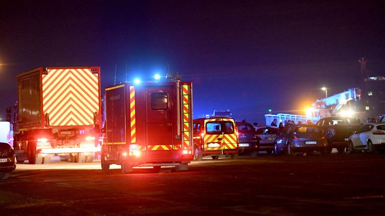 This photograph taken on November 24, 2021 shows fire trucks arriving at Calais harbour after 27 migrants died in the sinking of their boat off the coast of Calais. (Photo by FRANCOIS LO PRESTI / AFP) (Photo by FRANCOIS LO PRESTI/AFP via Getty Images)
