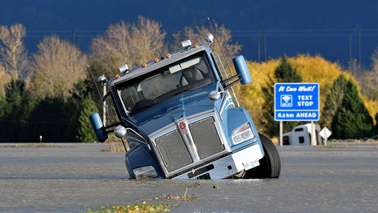 A truck is partially submerged on a flooded stretch of the Trans-Canada highway after rainstorms lashed the western Canadian province of British Columbia, triggering landslides and floods and shutting highways, in Abbotsford, British Columbia, Canada November 16, 2021. REUTERS/Jennifer Gauthier
