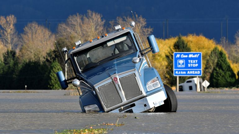 A truck is partially submerged on a flooded stretch of the Trans-Canada highway after rainstorms lashed the western Canadian province of British Columbia, triggering landslides and floods and shutting highways, in Abbotsford, British Columbia, Canada November 16, 2021. REUTERS/Jennifer Gauthier
