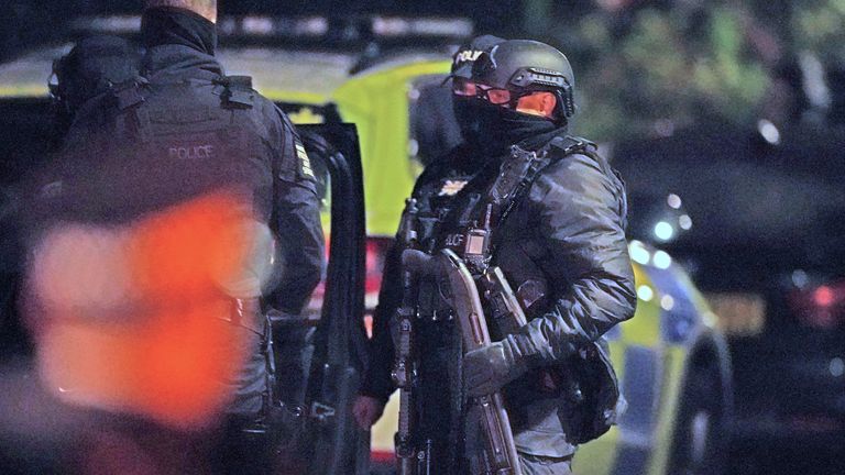 An armed police officer holds a breaching shotgun, used to blast the hinges off a door, at an address in Rutland Avenue in Sefton Park, after an explosion at the Liverpool Women&#39;s Hospital killed one person and injured another. Three men have been arrested under the Terrorism Act. 