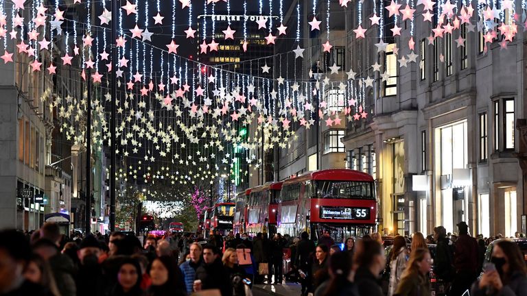 Bus passengers and shoppers view a Christmas light display along Oxford Street, London, Britain, November 20, 2021. REUTERS/Toby Melville
