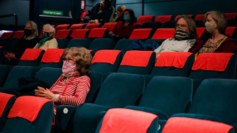 Cinema audiences watch a movie theatre screen at Chapter, in Cardiff, after lockdown restrictions eased in May 