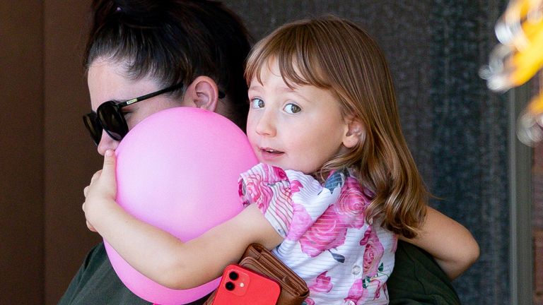 Cleo and her mum leaving a house where they spent the night after the four-year-old was rescued. Pic: AP