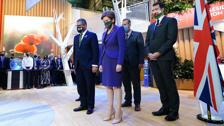 Cop26 President Alok Sharma (front left) and First Minister Nicola Sturgeon observe a two minute silence to remember the war dead on Armistice Day in the UK Pavilion at the Scottish Event Campus (SEC) in Glasgow during the Cop26 climate summit. Picture date: Thursday November 11, 2021.
