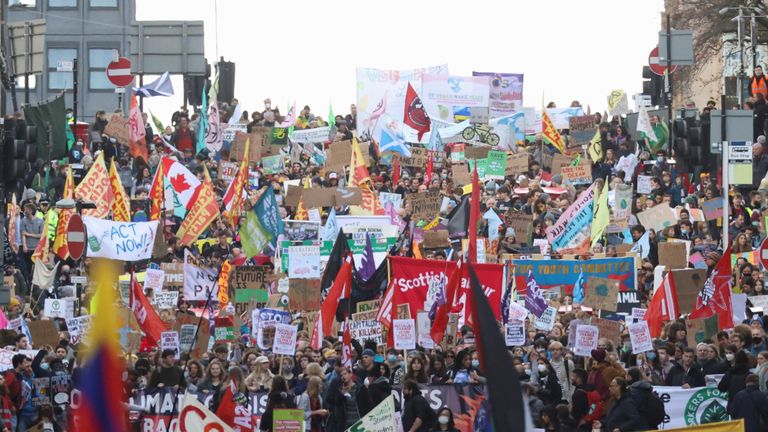 Demonstrators carry signs and flags at a Fridays for Future march during the UN Climate Change Conference (COP26), in Glasgow, Scotland, Britain, November 5, 2021. REUTERS/Yves Herman
