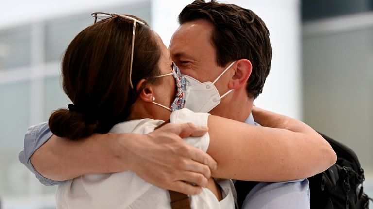 A couple, Matthew and Anthea Whitehead, are reunited at Sydney Airport in the wake of coronavirus disease (COVID-19) border restrictions easing, with fully vaccinated Australians being allowed into Sydney from overseas without quarantine for the first time since March 2020, in Sydney, Australia, November 1, 2021. REUTERS/Jaimi Joy
