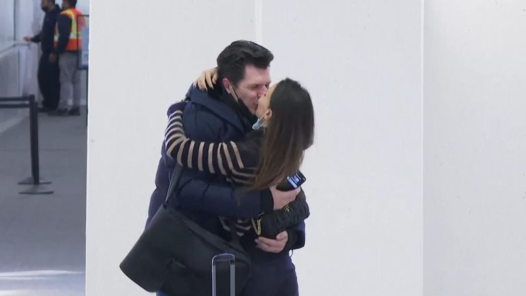 A couple reunite at Newark Airport in New Jersey after flights to the US restarted