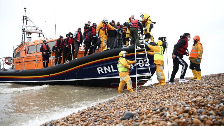 Migrants are brought ashore onboard a RNLI Lifeboat, after having crossed the channel, in Dungeness, Britain, November 24, 2021. REUTERS/Henry Nicholls
