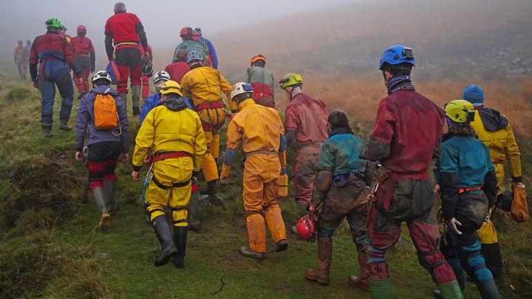 Rescuers walk towards the Ogof Ffynnon Ddu cave system near Penwyllt, Powys in the Brecon Beacons, Wales, as rescue mission is underway to save a man who has been trapped inside a cave, after falling on Saturday. Because of the injuries suffered in the fall the trapped man is said to be unable to climb out of the cave. Picture date: Monday November 8, 2021.
