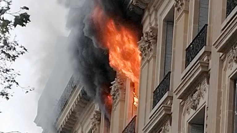 Fire and smoke rise from a building near Place de l'Opéra in Paris
