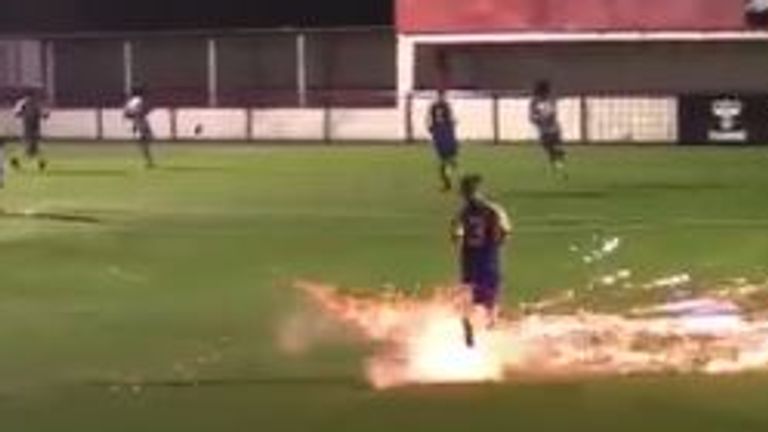 A Hashtag United player was lucky to escape injury after a firework landed on the pitch. Pic: Hashtag United/Twitter