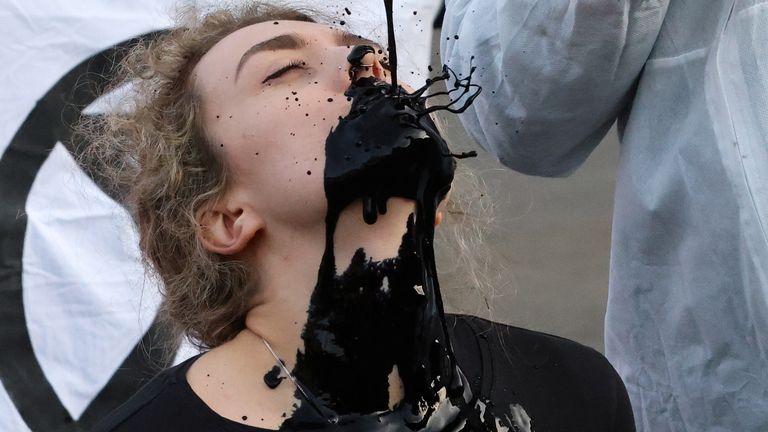 Protest against fossil fuel industry, in Glasgow
A man pours fake fuel on the face of a protester as they perform at a demonstration against the fossil fuel industry during the UN Climate Change Conference (COP26), in Glasgow, Scotland, Britain, November 7, 2021. REUTERS/Yves Herman