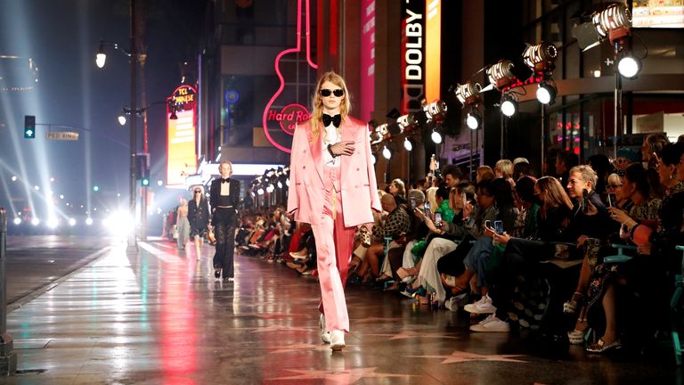 Models walk on the sidewalk of Hollywood Blvd during the Gucci Love Parade fashion show in Los Angeles, California, U.S., November 2, 2021. REUTERS/Mario Anzuoni
