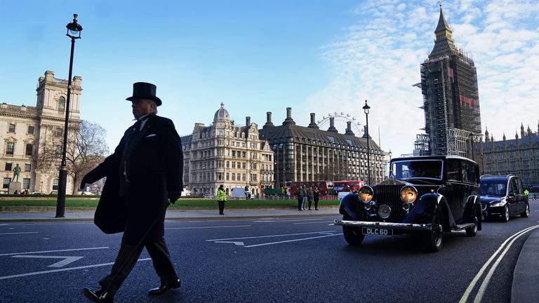 The hearse carrying the coffin of Sir David Amess MP crosses Parliament Square after leaving the Palace of Westminster where it laid in the chapel overnight, ahead of a requiem mass at Westminster Cathedral, central London. Picture date: Tuesday November 23, 2021.
