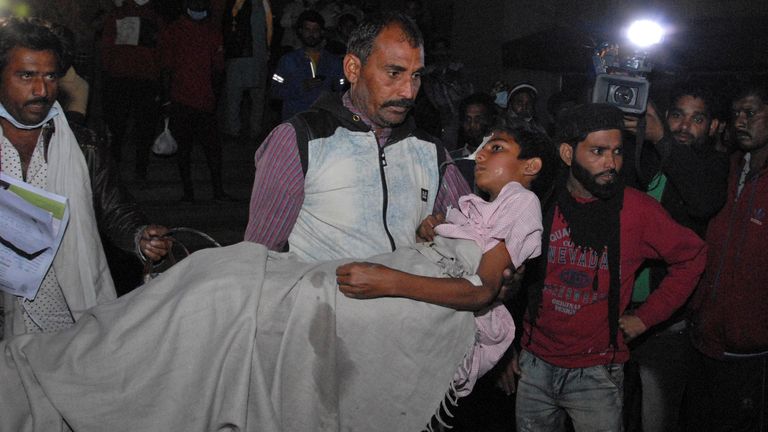 A man carries a child out from the Kamla Nehru Children’s Hospital after a fire in the newborn care unit of the hospital killed four infants, in Bhopal, India, Monday, Nov. 8, 2021. There were 40 children in total in the unit, out of which 36 have been rescued, said Medical Education Minister Vishwas Sarang. (AP Photo)


