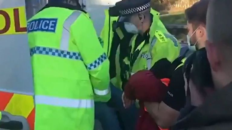 Police detain an Insulate Britain protester in Hertfordshire