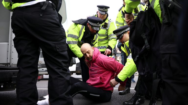 Police officers detain an Insulate Britain activist as they block a road outside the Houses of Parliament during a protest in London, Britain November 4, 2021. REUTERS/Henry Nicholls
