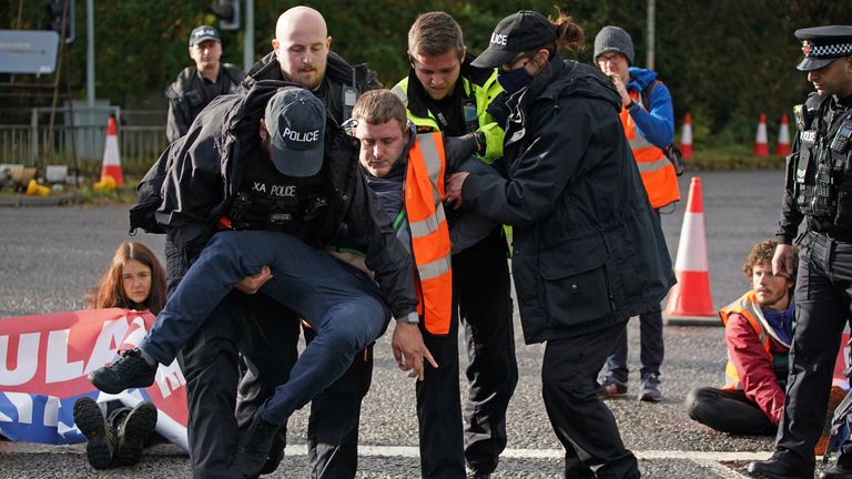 Protesters from Insulate Britain are removed by police after they blocked a road near to the Holiday Inn Express Motorway Airport in Manchester. Picture date: Tuesday November 2, 2021.