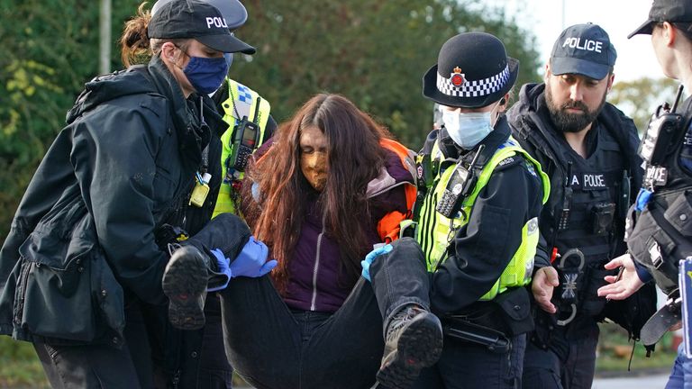 Protesters from Insulate Britain are removed by police after they blocked a road near to the Holiday Inn Express Motorway Airport in Manchester. Picture date: Tuesday November 2, 2021.