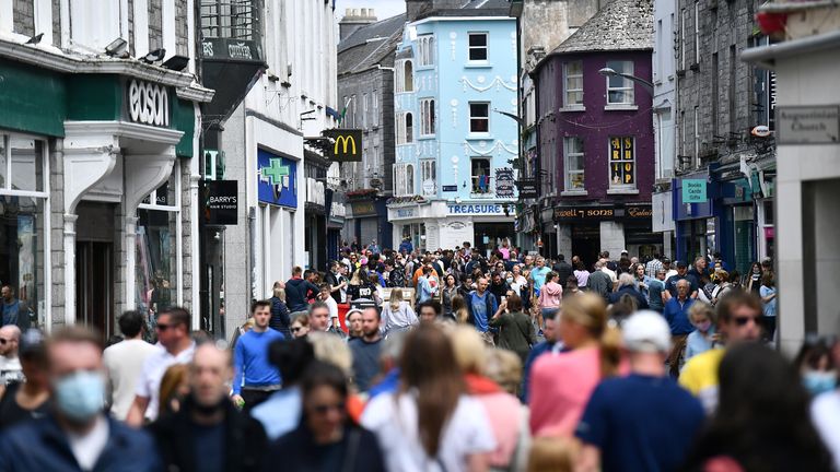 People walk outside as outdoor services in restaurants and bars recommences in Ireland as restrictions ease following the coronavirus disease (COVID-19) outbreak, in Galway, Ireland, June 7, 2021. REUTERS/Clodagh Kilcoyne