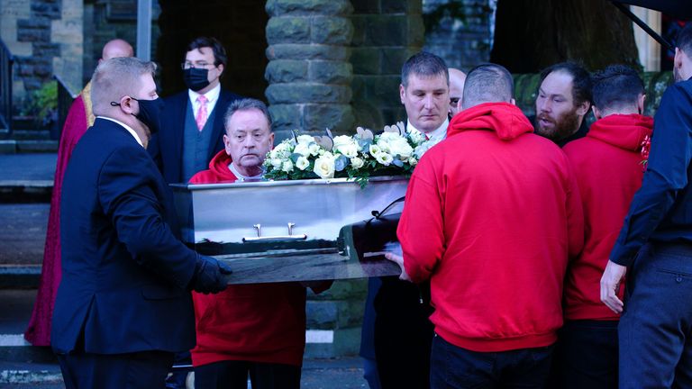 The coffin of Jack Lis is carried into church