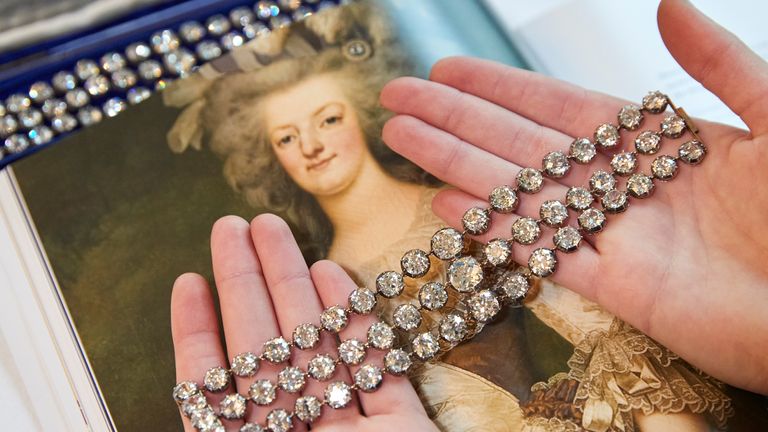 A staff diplays a pair of diamond bracelets, with approximately 140 to 150 carats and owned by Queen Marie-Antoinette of France, in silver and yellow gold, circa 1776, during a preview at Christie&#39;s before their auction sale in Geneva, Switzerland, November 3, 2021. REUTERS/Denis Balibouse