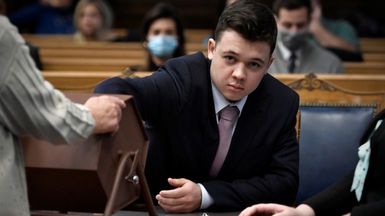 Kyle Rittenhouse pulls numbers of jurors out of a tumbler during his trial at the Kenosha County Courthouse in Kenosha, Wisconsin, U.S., November 16, 2021. Sean Krajacic/Pool via REUTERS
