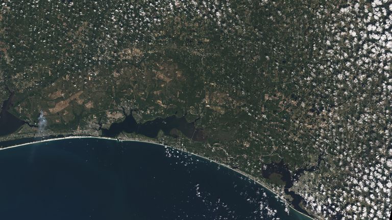 The white sands of Pensacola Beach stand out in this Landsat 9 image of the Florida Panhandle of the United States, with Panama City visible under some popcorn-like clouds. Landsat and other remote sensing satellites help to track changes to US coastlines, including urban development and potential impacts of rising sea levels. 