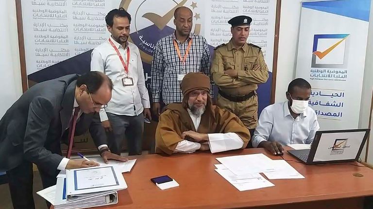 Seif al-Islam, center, the son and one-time heir apparent of late Libyan dictator Moammar Gadhafi registers his candidacy for the country’s presidential elections next month