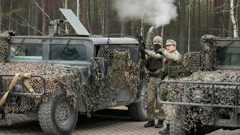 Lithuanian army servicemen are seen at the border guard headquarters near the border with Belarus, in Kapciamiestis, Lithuania November 10, 2021. RUTERS/Ints Kalnins  