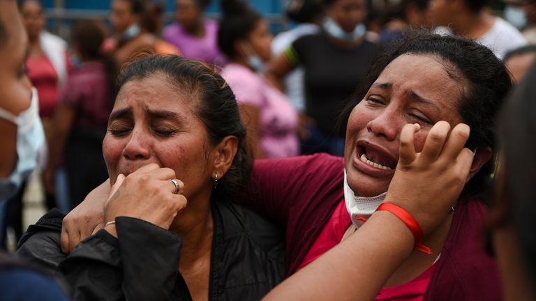 Family members react as they stand outside the Litoral Penitentiary in Guayaquil, Ecuador 