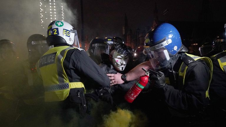 Police clash with protesters as they take part in the Million Mask March 2021 in Parliament Square, London. Picture date: Friday November 5, 2021.