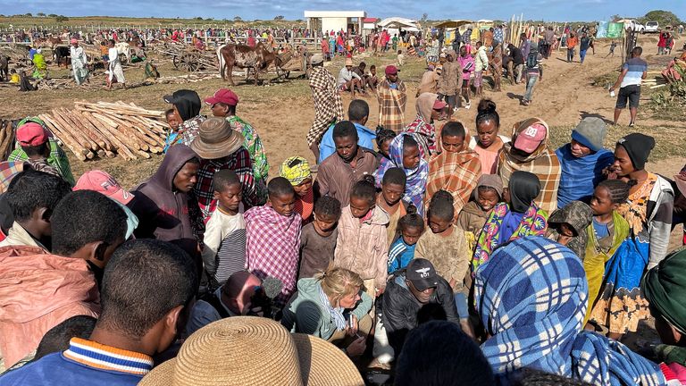 The Sky team talks to sweet potato sellers at the livestock market