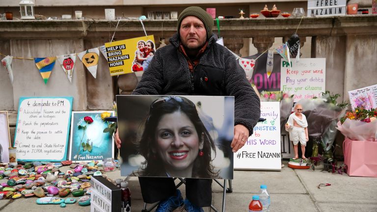 Richard Ratcliffe, husband of British-Iranian aid worker Nazanin Zaghari-Ratcliffe, holds Nazanin&#39;s picture during the 19th day of a hunger strike outside the Foreign, Commonwealth and Development Office (FCDO), in London, Britain, November 11, 2021. REUTERS/Peter Cziborra