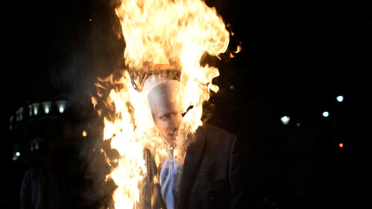 An effigy of Britain's Prime Minister Boris Johnson is set alight in Trafalgar Square. Pic: AP