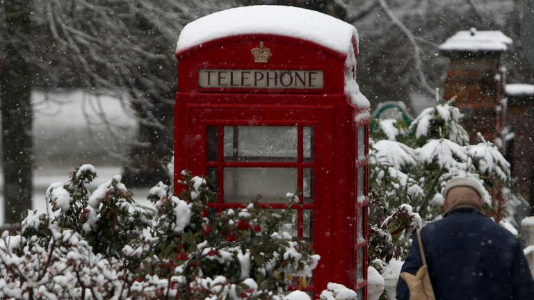A man walks past a snow covered phone box in Marlow, Buckinghamshire, as heavy snowfall across parts of the UK is causing widespread disruption, closing roads and grounding flights at an airport. PRESS ASSOCIATION Photo. Picture date: Sunday December 10, 2017. 