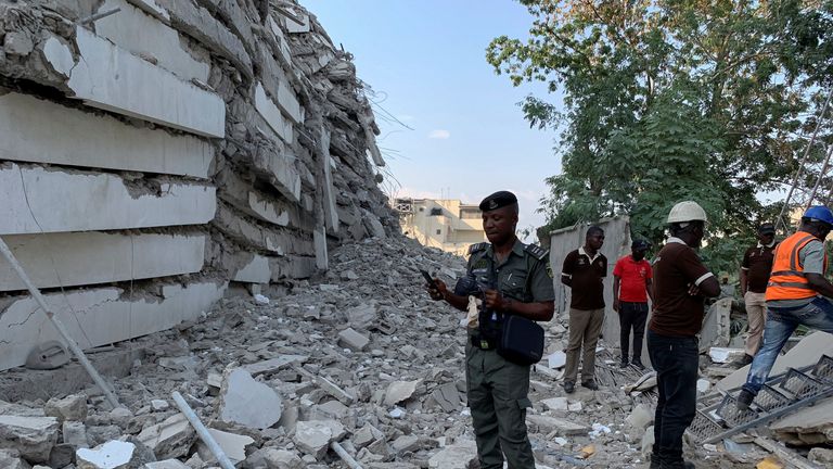 A policeman stands by the debris of the collapsed building in Ikoyi, Lagos, Nigeria, November 1, 2021. Picture taken November 1, 2021. REUTERS/Nneka Chile
