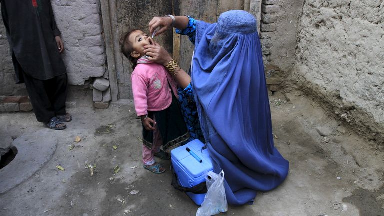 A child receives a polio vaccination during an anti-polio campaign on the outskirts of Jalalabad, Afghanistan, December 1, 2015. REUTERS/Parwiz