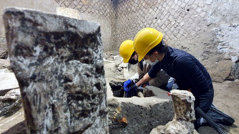 Archaeologists work inside a "slaves room" discovered at a Roman villa near the ancient Roman city of Pompeii, destroyed in 79 AD in volcanic eruption, Italy, 2021