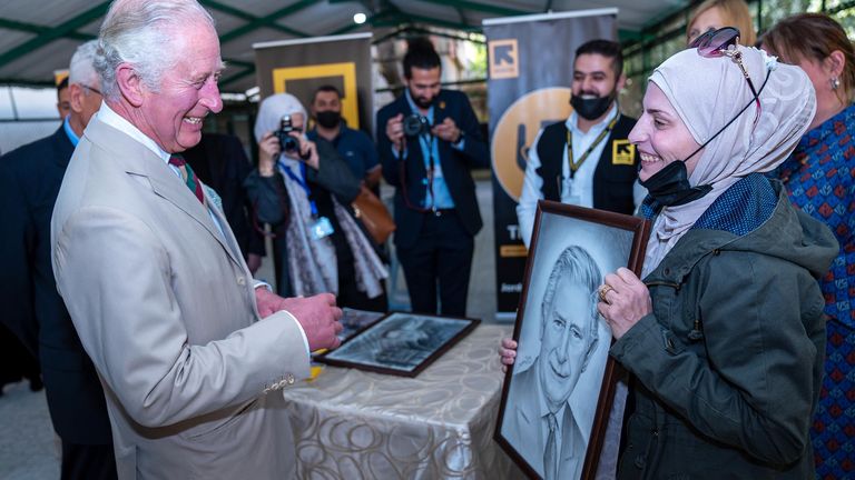 The Prince of Wales admires his portrait given to him by the Syrian refugee artist Faihaa, 38, during a visit to the Al Nuzha Community Centre in Jordan, on the second day of the Royal tour of the Middle East. Picture date: Wednesday November 17, 2021.