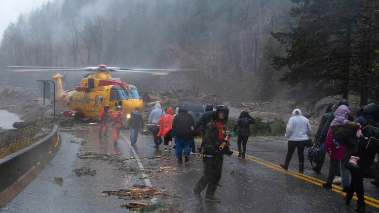 Picture date 15 November 2021
Crew members from Royal Canadian Air Force 442 Squadron lead some of over 300 motorists stranded by mudslides towards a CH-149 Cormorant helicopter for their evacuation, in Agassiz, British Columbia, Canada November 15, 2021. Picture taken November 15, 2021. RCAF/Handout via REUTERS MANDATORY CREDIT. THIS IMAGE HAS BEEN SUPPLIED BY A THIRD PARTY.
