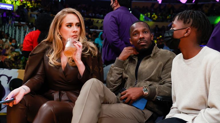 Singer Adele, left, and Rich Paul, center, attend an NBA basketball game between the Golden State Warriors and the Los Angeles Lakers in Los Angeles, Tuesday, Oct. 19, 2021. (AP Photo/Ringo H.W. Chiu)