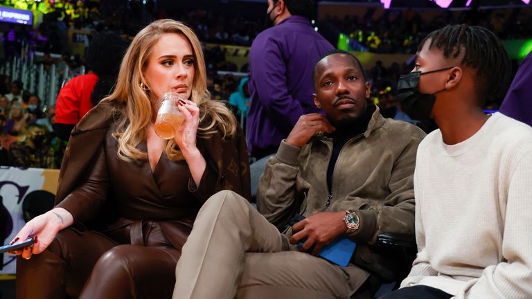 Singers Adele, left, and Rich Paul, center, attend the NBA basketball game between the Golden State Warriors and the Los Angeles Lakers in Los Angeles, Tuesday, October 19, 2021. (AP Photo/Ringo HW Chiu)