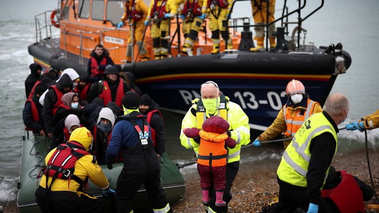 Migrants are brought ashore by RNLI Lifeboat staff, after having crossed the channel, in Dungeness, Britain, November 24, 2021. REUTERS/Henry Nicholls
