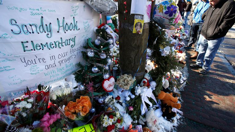 People look at a makeshift memorial in Sandy Hook, after the 2012 shooting tragedy when a gunman shot dead 20 students and six adults at Sandy Hook Elementary
