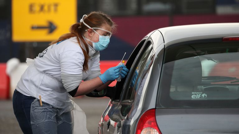 A staff member takes a sample at a COVID-19 testing centre amid the coronavirus disease outbreak, at Glasgow Airport, in Glasgow, Scotland April 29, 2020. Andrew Milligan/Pool via REUTERS
