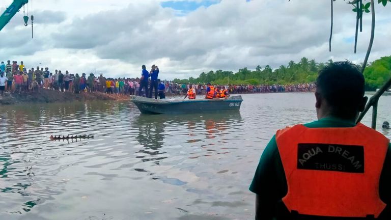 Sri Lankan police and navy life savers attend the rescue work following a ferry capsized in Kinniya, about 267 kilometres east of Colombo, Sri Lanka on Tuesday, Nov. 23, 2021. (AP Photo/Mangalanath Liyanaarachchi)