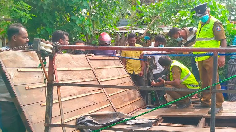Sri Lankan police officers inspect the capsized ferry in Kinniya, about 267 kilometres east of Colombo, Sri Lanka on Tuesday, Nov. 23, 2021. At least six people are dead after a ferry capsized in eastern Sri Lanka on Tuesday, said Navy spokesperson Capt. Indika de Silva. At least 12 others have been rescued. (AP Photo/Mangalanath Liyanaarachchi) 