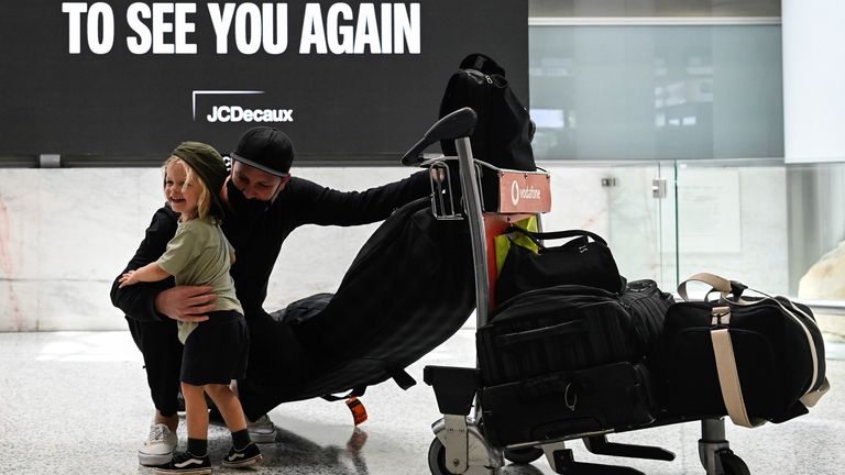 Father and son are reunited at Sydney Airport in the wake of coronavirus disease (COVID-19) border restrictions easing, with fully vaccinated Australians being allowed into Sydney from overseas without quarantine for the first time since March 2020, in Sydney, Australia, November 1, 2021. REUTERS/Jaimi Joy
